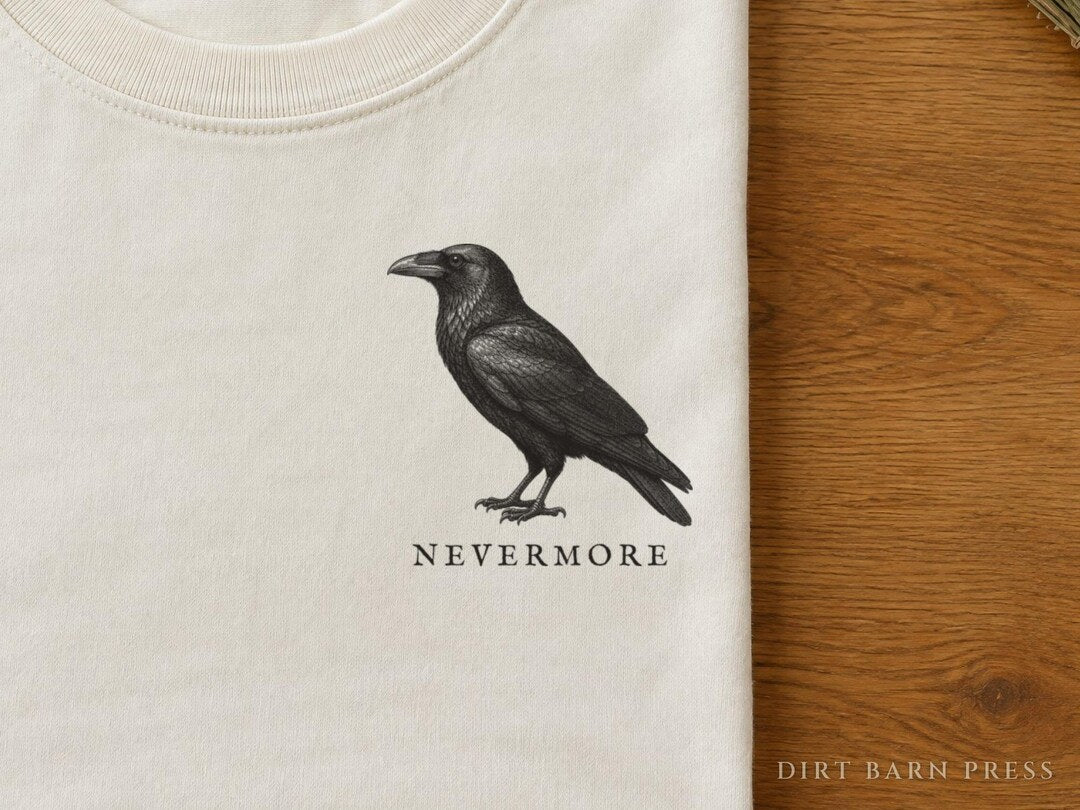 Cream tee with a raven engraving and the word Nevermore